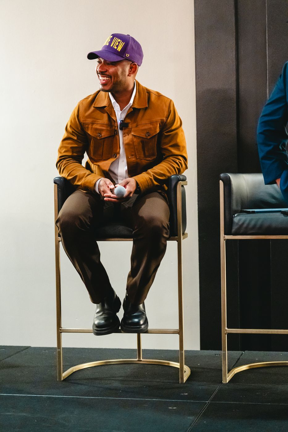 Rashiid Marcell on stage at a panel